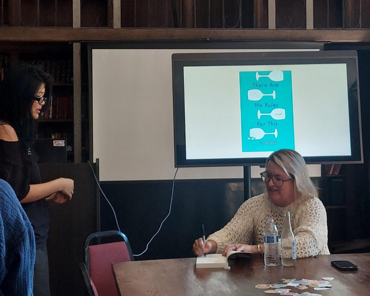 Author JJ Elliot signs copies of "There Are No Rules for This". During Women's Group Meeting in the Otto Library. // Photo Provided by Ms. Carino Peterson
