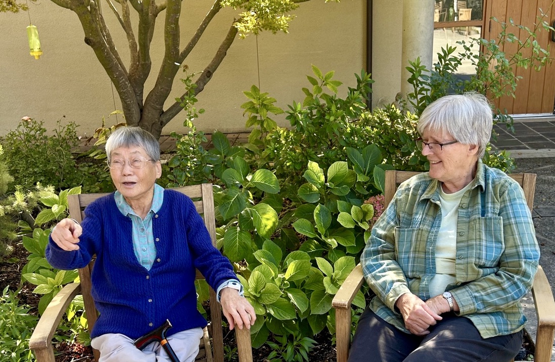 Sister Yungja Park and Sister Suzanne Lassiegne sitting at Oakwood sharing stories.