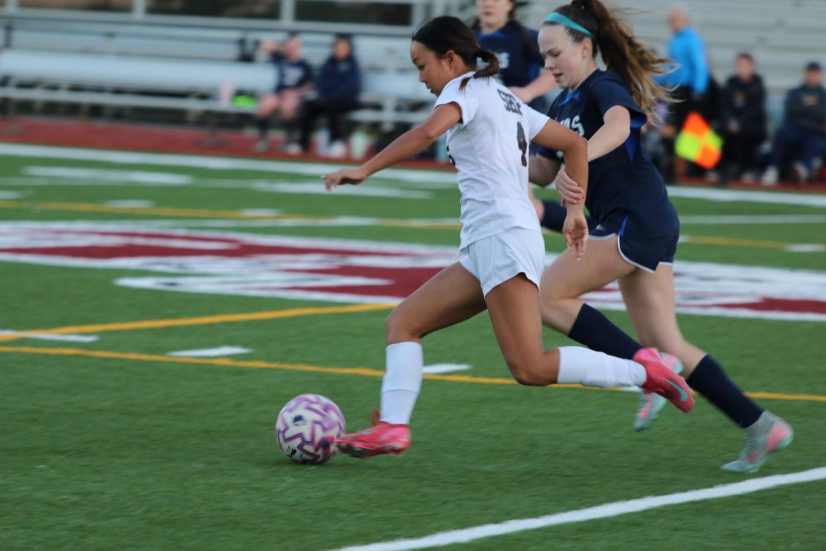 Aris Yu ‘28 dribbles past opponent // Provided by Jing Yi through Vidigami
