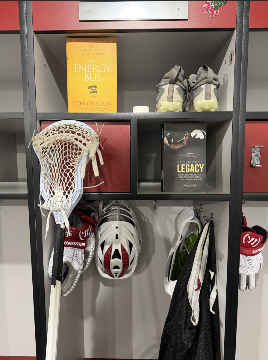 Athletics locker containing lacrosse equipment as well as the two texts read in the book club.