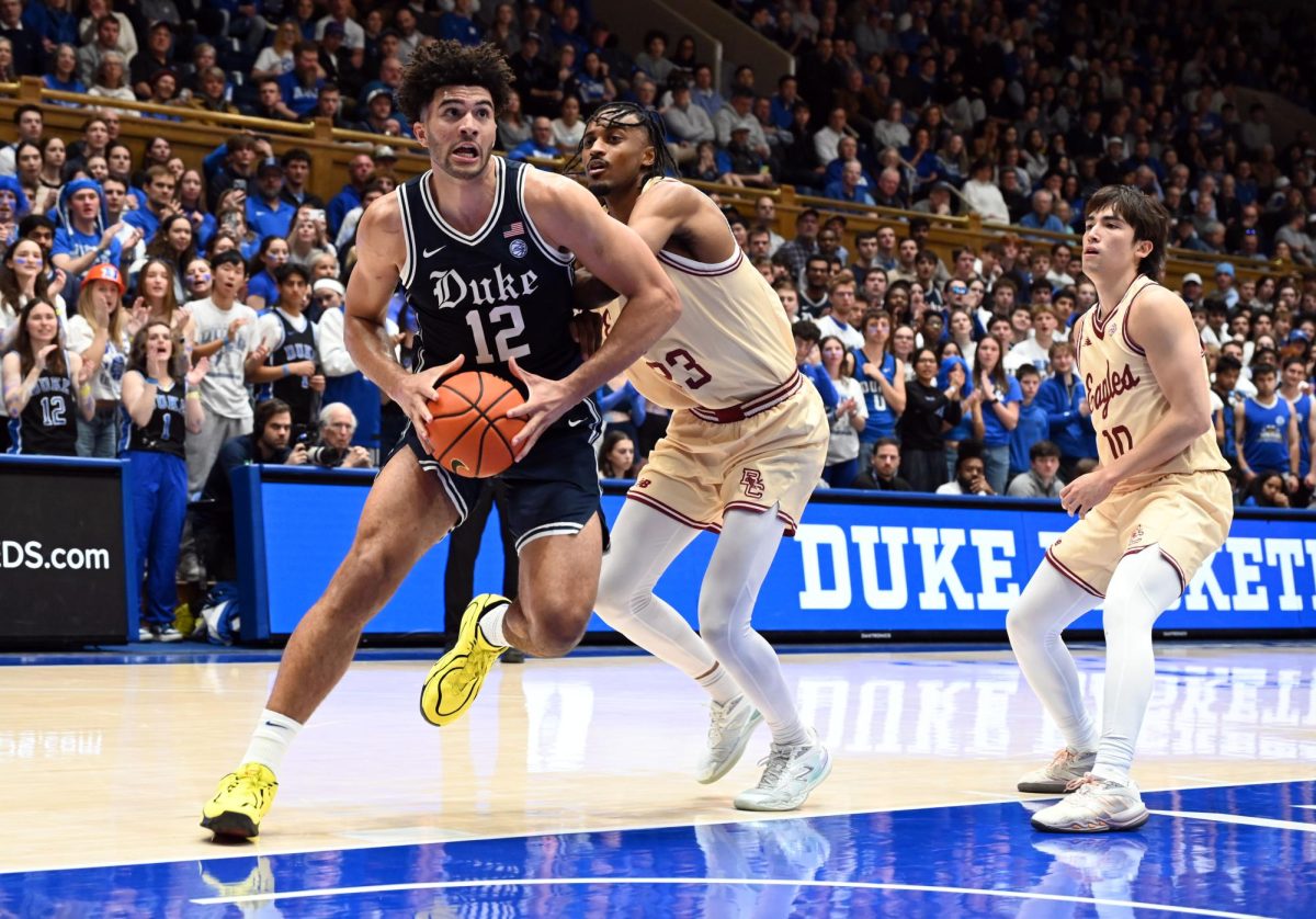 Feb 3, 2026; Durham, North Carolina, USA;  Duke Blue Devils forward Cameron Boozer (12) drives to the basket as Boston College Eagles forward Aiden Shaw (23) defends during the second half at Cameron Indoor Stadium. Mandatory Credit: Rob Kinnan-Imagn Images
