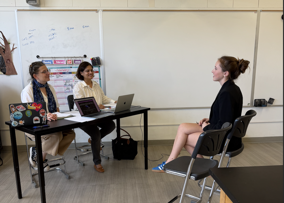 Lucy Irvine '27 presents her National History Day project to judges at the county level.