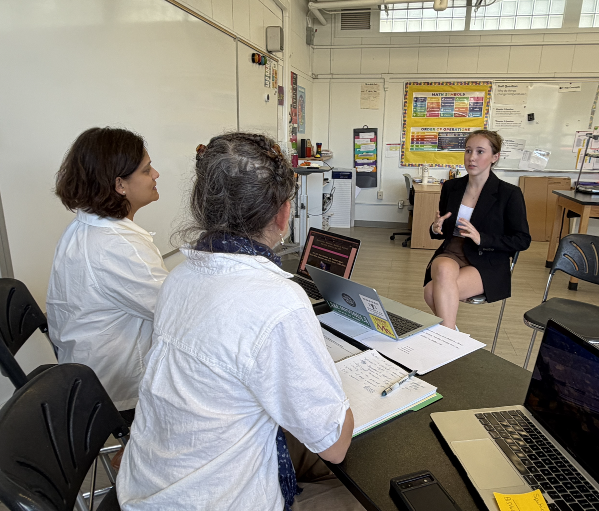 Lucy Irvine '27 presents her National History Day project to judges at the county level.